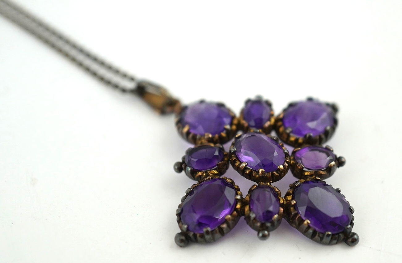 An amethyst pendant, 40mm, on a 9ct gold chain. Condition - fair